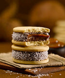 Cachafaz "Alfajor Maizena" Cookie filled with Dulce de Leche decorated with shredded coconut 12Units